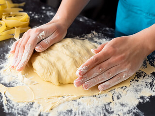 person kneading dough