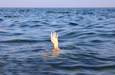 hand desperately reaching from the sea waves evokes deep emotions of failure and depression