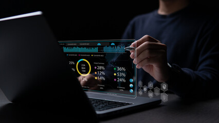 businesspeople or an accountant person are analyzing data charts, graphs, and a dashboard on a laptop screen.  metrics connected to the database for technology finance.