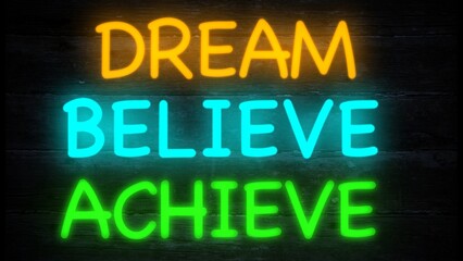 dream, believe, achieve neon effect sign on a dark wooden background