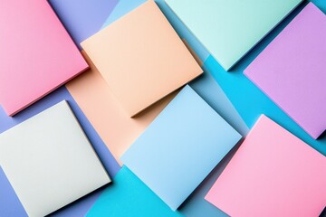 Fototapeta premium Colorful paper sheets arranged creatively on a vibrant background.