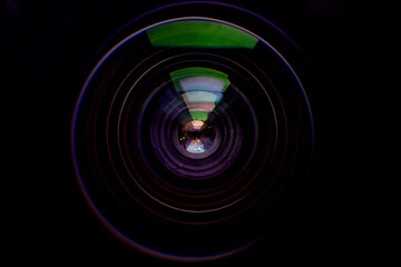Close-up lens,Photo or video camera lens with light reflections close-up on the black background.