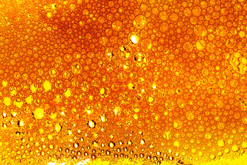 Yellow drink bubble texture close-up,Beer Background Ice Cold Pint With Water Drops...