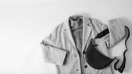 Monochrome look style. Light grey wool coat or jacket, dark grey cashmere sweater and black leather...