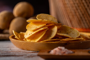 Potato chips on a wooden table.

