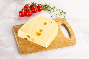 Maasdam cheese brick over board