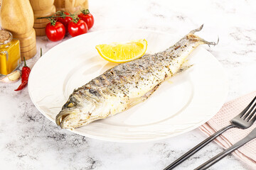 Grilled sea bass fish served lemon