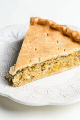 Chicken and egg pie on a light plate