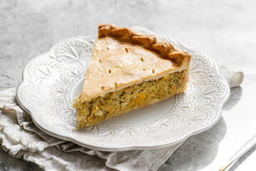Chicken and egg pie on a light plate
