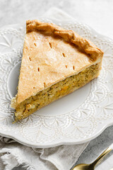 Chicken and egg pie on a light plate