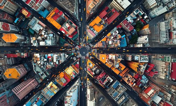 Aerial view of an urban intersection showcasing vibrant buildings and busy streets.