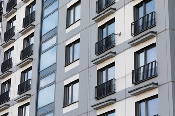 High-rise apartment buildings in a residential area showcasing windows and balconies during...
