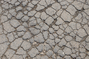 Abstract shapes, patterns and textures of cracked asphalt roads.Damaged asphalt road surface. for graphic design or banner background