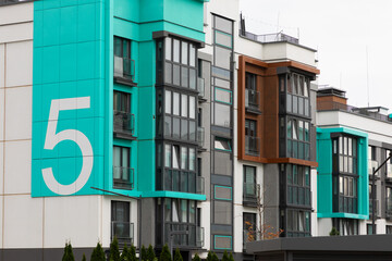 Modern high-rise apartment buildings with distinctive blue accents in a residential area highlighting urban living trends