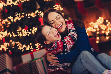 Photo of cute family mother little daughter cuddle cheerful dressed christmas garment tradition atmosphere decor house indoors room