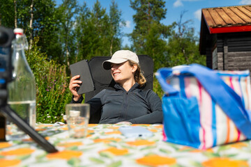 Woman reading an ebook outdoors in Sweden