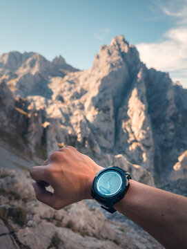 Unrecognizable hiker checking altitude on smartwatch in Picos de Europa