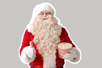 Santa Claus with tasty popcorn showing thumb-up on grey background