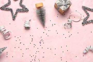 Composition with gift box and Christmas decor on pink background