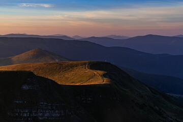 sunset in the highlands, the road passes along the top of the mountain range