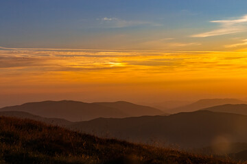 mountain ranges in orange light at sunset