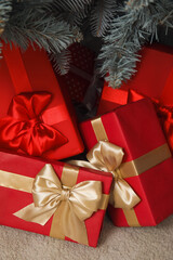 Gift boxes under Christmas tree in living room