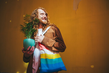 Proud man with flowing red hair carries a plant and rainbow bag, representing pride and uniqueness...