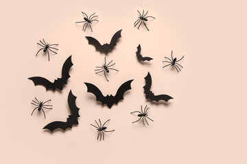 Paper bats and spiders for Halloween party on light background