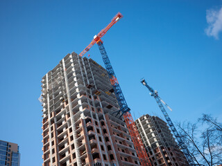 Residential high-rise building construction. Clear sky on construction place.