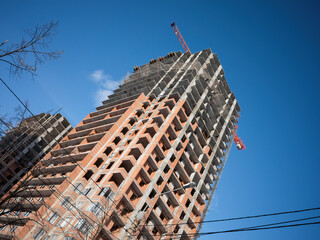 Residential high-rise building construction. Clear sky on construction place.