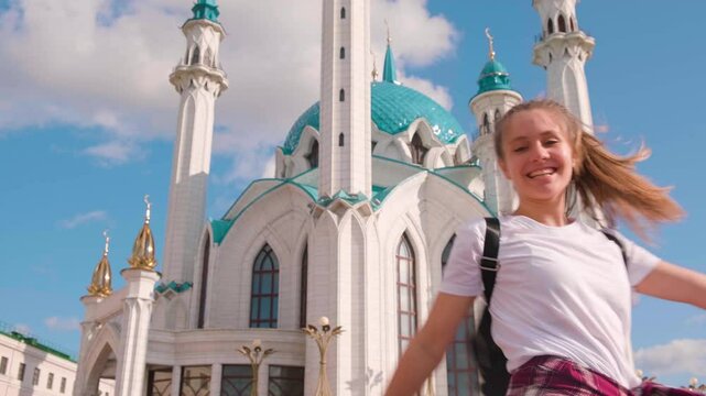 Beautiful tourist girl at kul sharif mosque on a sunny summer day in Kazan, Tatarstan.