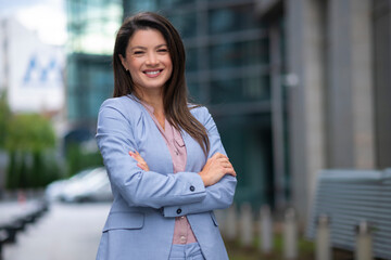 Portrait of business woman standing outdoor in blue suit