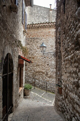 A steep and cobbled alleyway in the hilltop town of Saint Paul de Vence in the south of France