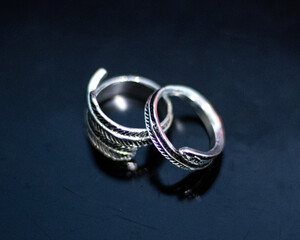 Close-up of Silver Rings with Intricate Design on Dark Background