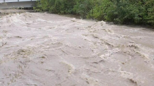 the waters of the river rise up, slamming the foot