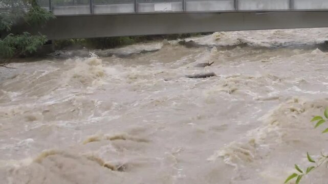 a city river during flooding after heavy rains 1