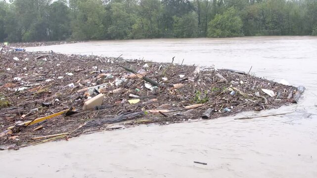piles of garbage in the river during flooding afte