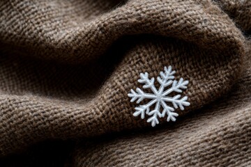 Cozy Brown Woolen Fabric with Embroidered White Snowflake: Warm Textures and Winter Themes in Stock Photography