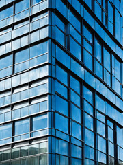 Fototapeta premium Urban modern building with a sleek geometric steel facade and reflective glass, representing contemporary architectural trends in city design. Generative AI