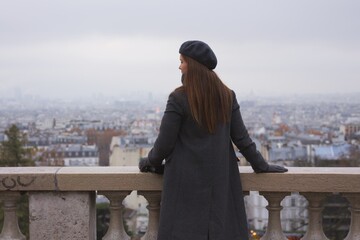 Contemplating Paris from Montmartres Viewpoint on a Misty Day 