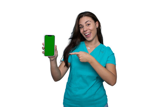 Confident young nurse in scrubs using a smartphone featuring a green screen - Powered by Adobe