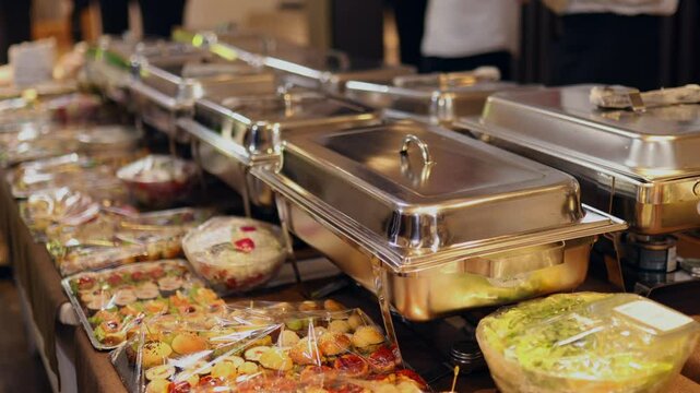 A sumptuous buffet spread features a variety of dishes laid out in chafing dishes and platter settings, inviting guests to enjoy a delightful meal together in a festive atmosphere.