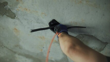 electrician pulling wires in an apartment at a construction site