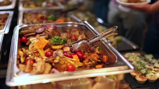 Guests are savoring a rich array of dishes at a buffet including fresh meats, vegetables, and tempting appetizers served on elegant platters.