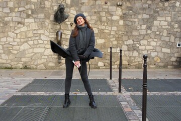 Laughing Woman at Le Passe-Muraille Sculpture on a Windy Day in Paris