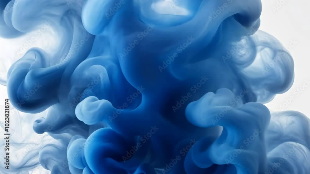 Poster blue ink swirls and dances in a clear liquid, creating abstract and ethereal patterns
