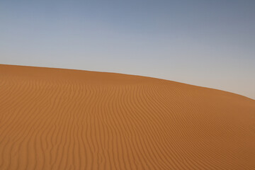 Orange Sand Dunes under a Blue Sky