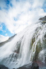 Dynjandi Waterfall, the tallest in Westfjords, Iceland, cascades down rugged cliffs with smaller...