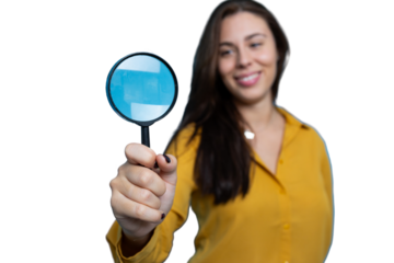 Portrait of a young businesswoman holding a magnifying glass
