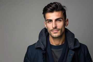 Obraz premium Young handsome man possing and modeling over grey isolated background
